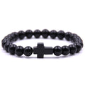 Black beaded bracelet with a cross charm on a white background
