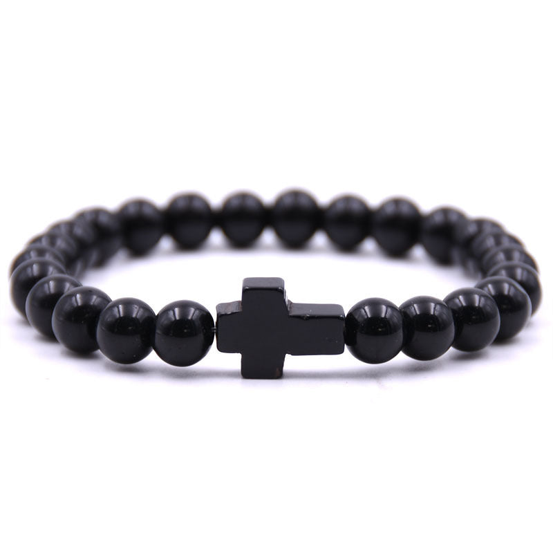 Black beaded bracelet with a cross charm on a white background