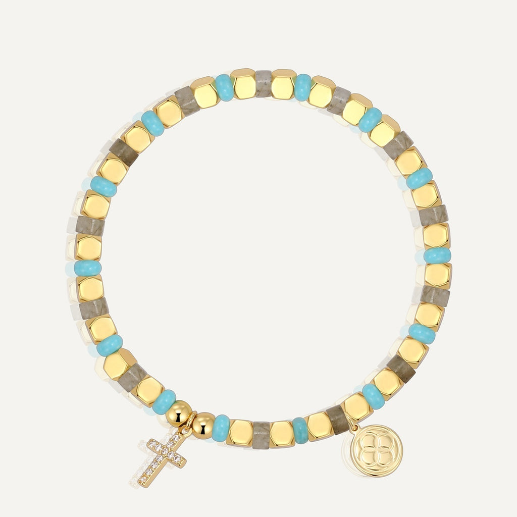 Multicolored beaded bracelet with a cross charm on a white background