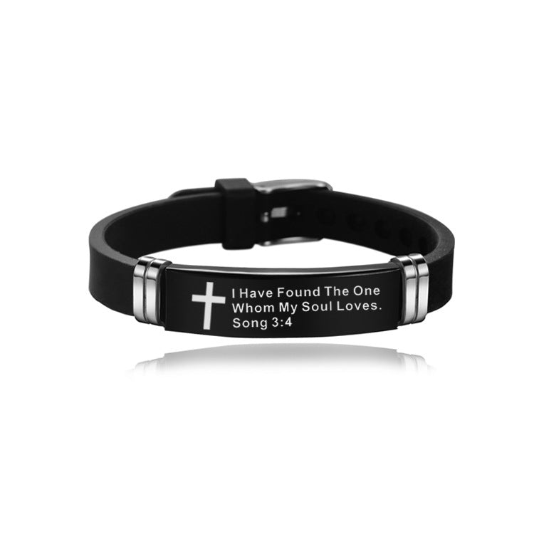 Black bracelet with silver accents and engraved text on a white background
