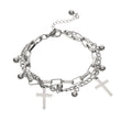 Silver chain bracelet with cross charms on a white background