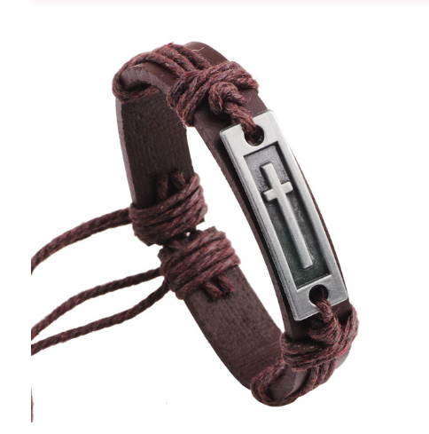 Brown braided leather bracelet with a silver cross charm on a white background