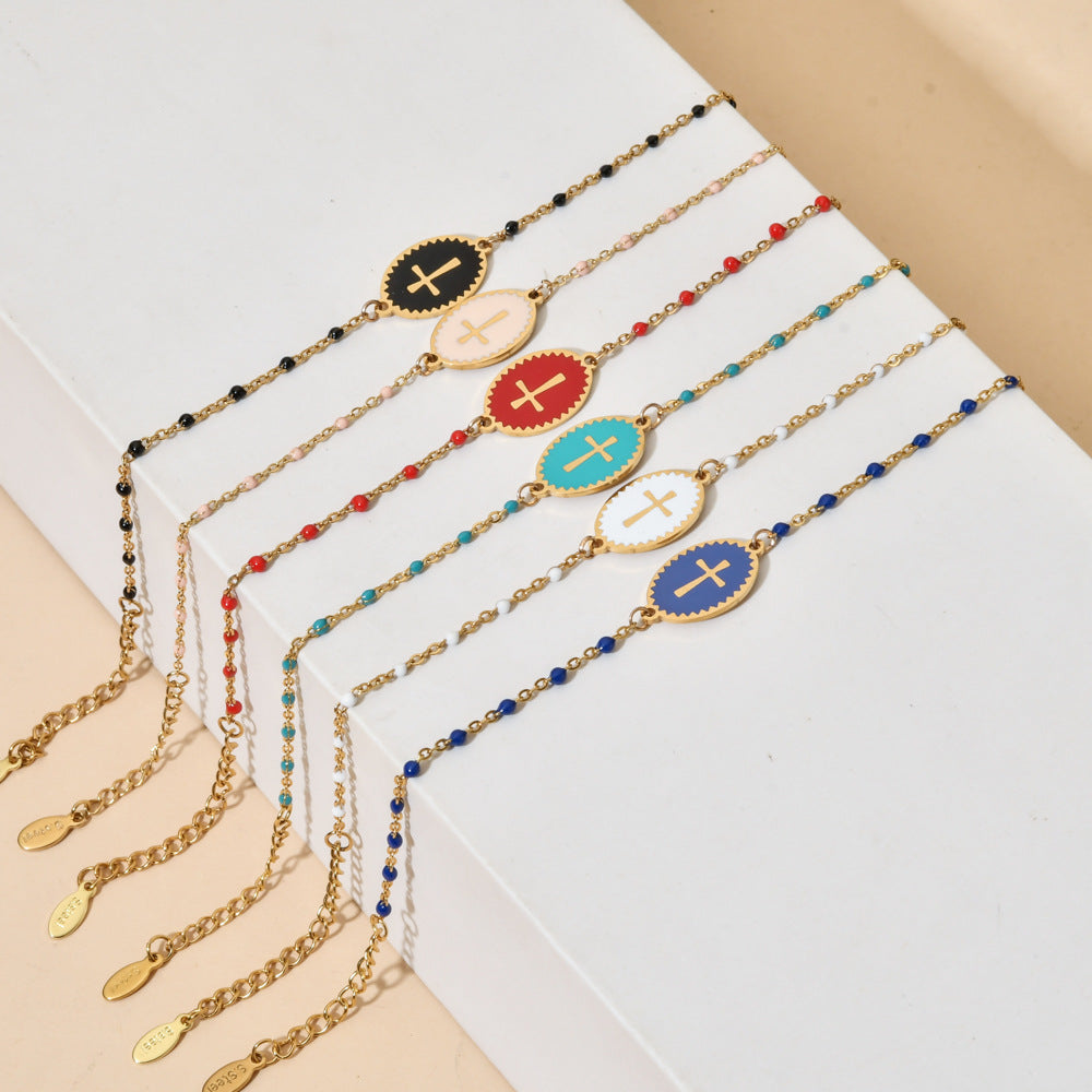 Set of gold necklaces with colorful pendants on a white surface