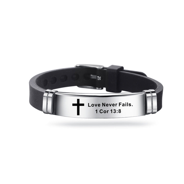 Black leather bracelet with silver tag featuring a cross and engraved text on a white background