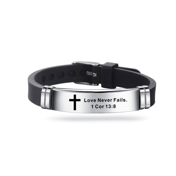 Black leather bracelet with silver tag featuring a cross and engraved text on a white background