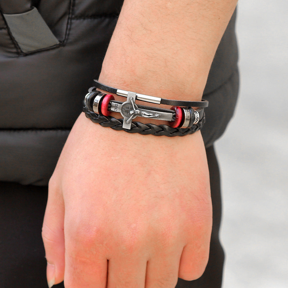 Bracelet with black, red, and silver elements on a wrist against a neutral background