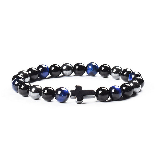 Black and blue beaded bracelet with a cross charm on a white background
