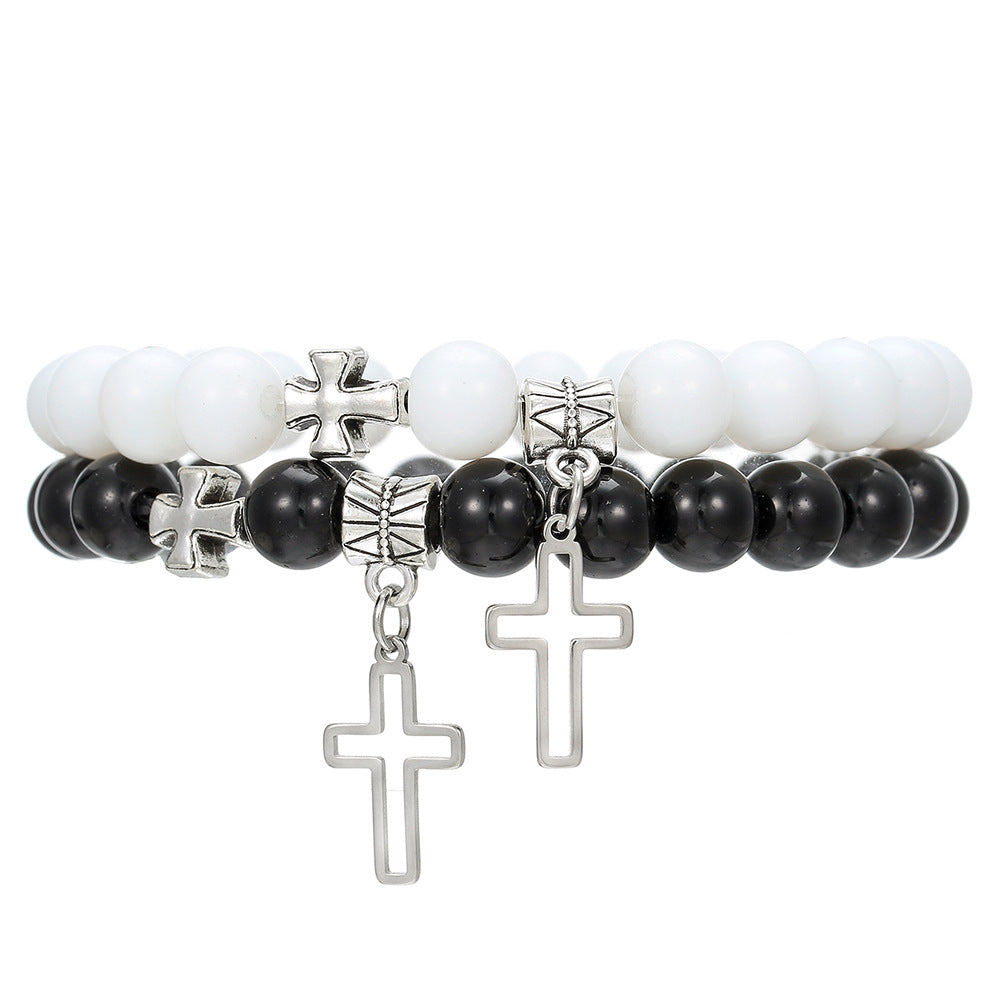 Two beaded bracelets with cross charms on a white background