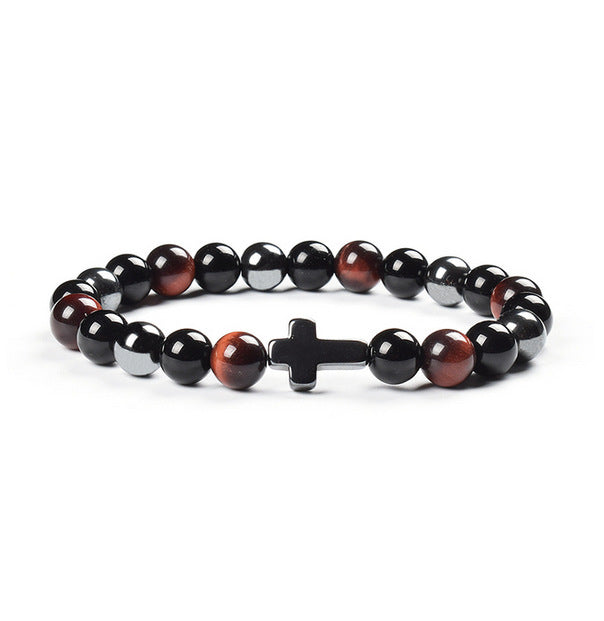 Bracelet with black, red, and white beads featuring a cross charm on a white background