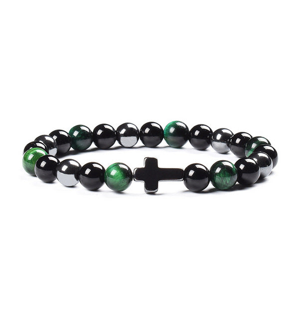 Beaded bracelet with a cross charm on a white background