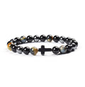 Black beaded bracelet with a cross charm on a white background